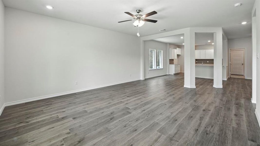Unfurnished living room with recessed lighting, dark wood-type flooring, and ceiling fan Unfurnished living room with recessed lighting, dark wood-type flooring, and ceiling fan