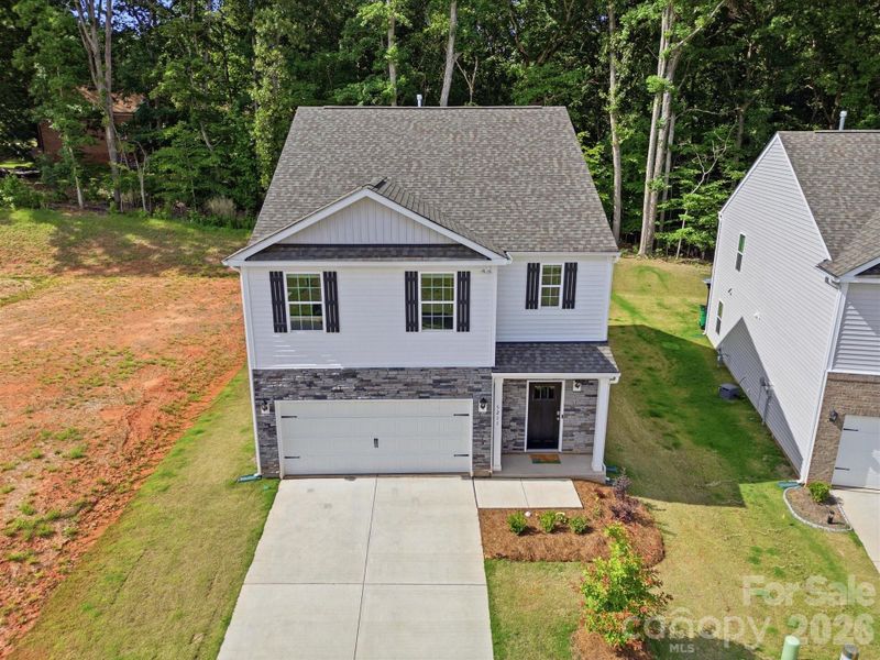 Front exterior of a new home in Reedy Creek Preserve, Charlotte, NC, highlighting curb appeal (Image 28).