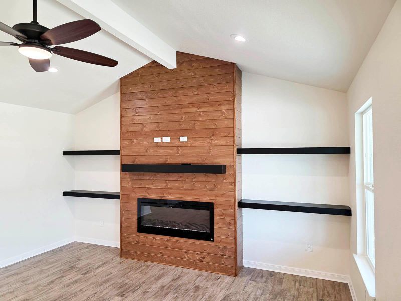 Unfurnished living room featuring a glass covered fireplace, light wood-type flooring, a ceiling fan, and recessed lighting