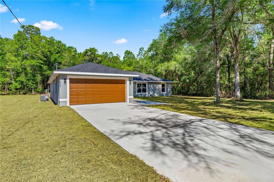 Front exterior of a new home in , Dunnellon, FL, highlighting curb appeal (Image 16).