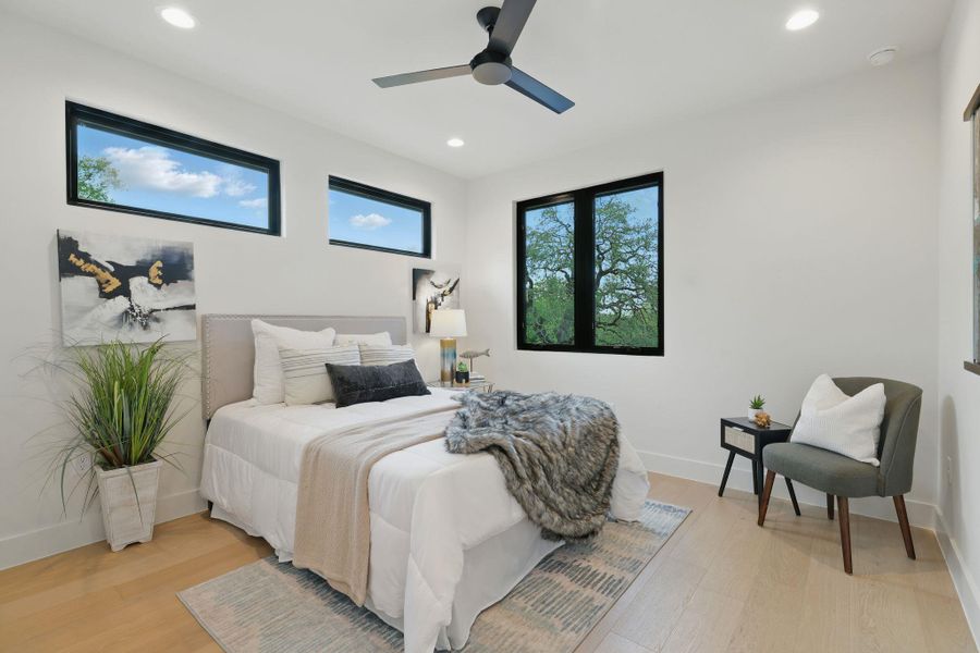 Bedroom with light wood-style flooring, recessed lighting, and a ceiling fan
