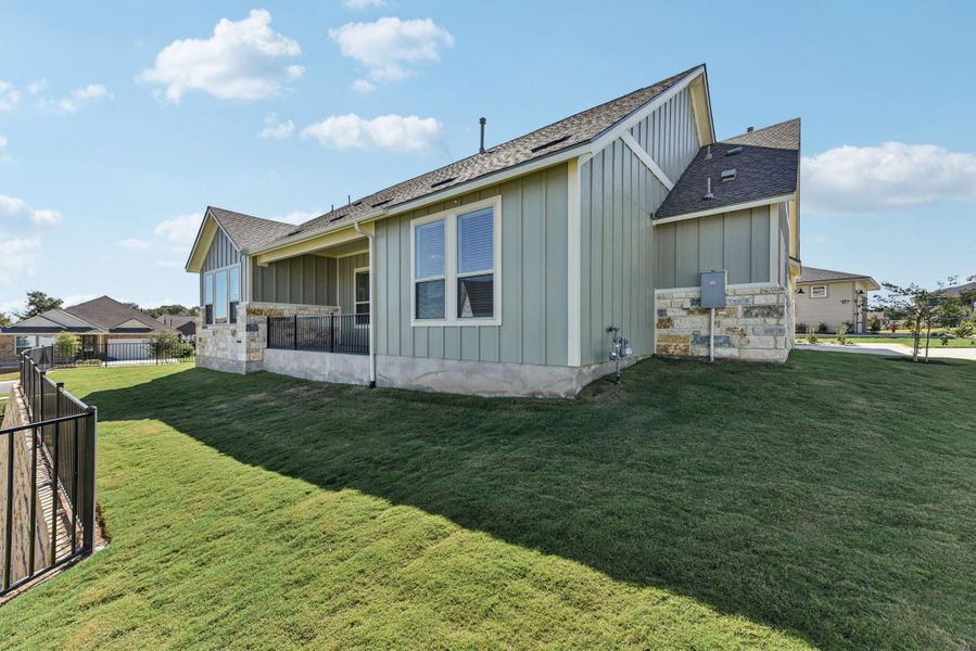 View of side of home featuring board and batten siding, a shingled roof, and a patio area View of side of home featuring board and batten siding, a shingled roof, and a patio area