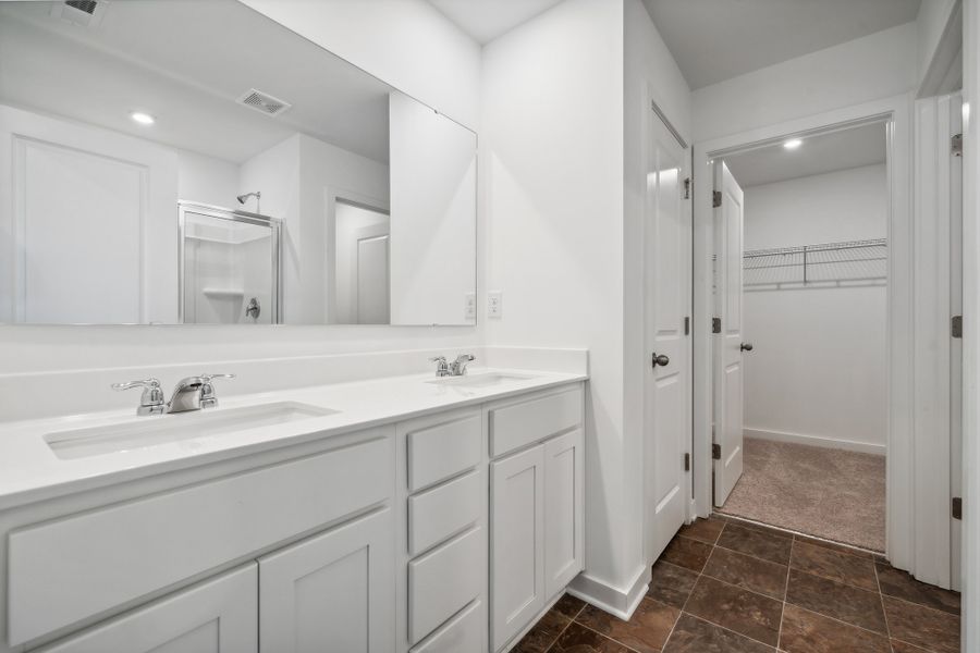 A bathroom with white cabinets. A bathroom with white cabinets.
