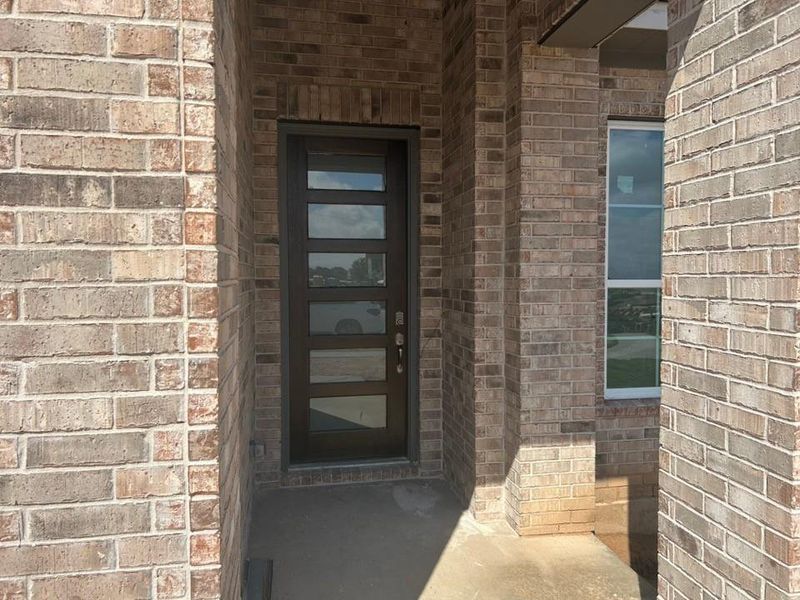 View of exterior entry featuring brick siding View of exterior entry featuring brick siding