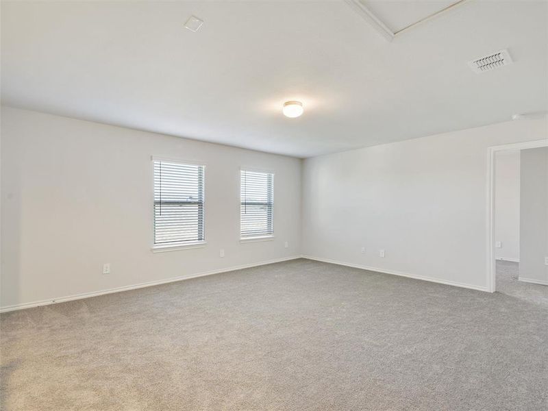 Carpeted spare room with baseboards and visible vents Carpeted spare room with baseboards and visible vents