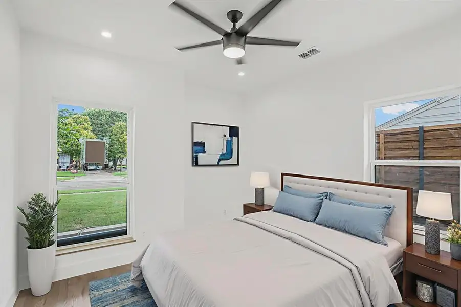 Bedroom with wood finished floors, recessed lighting, and a ceiling fan Bedroom with wood finished floors, recessed lighting, and a ceiling fan