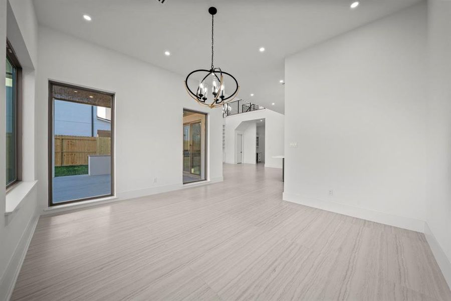 Elegant dining room with large windows and easy access to the covered patio, providing a bright and inviting space perfect for entertaining