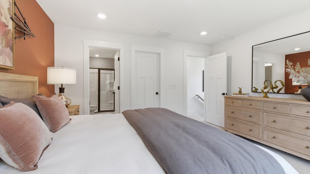 Vibrant natural light fills this exceptional primary suite of The Churchill Design with eye-catching details
