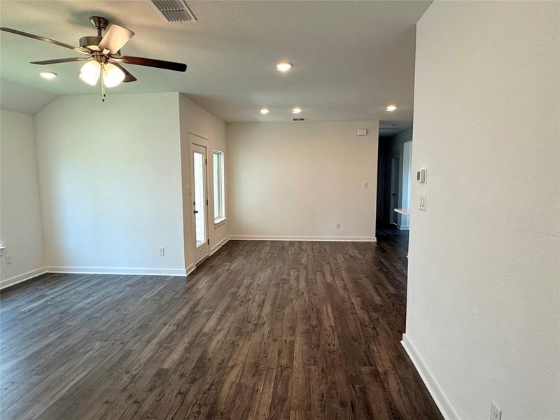Empty room with dark wood-type flooring, recessed lighting, and ceiling fan Empty room with dark wood-type flooring, recessed lighting, and ceiling fan