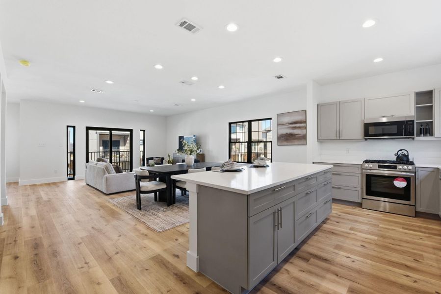 Oversized quartz countertop with bar seating, perfect for entertaining and casual gatherings. (Photos are from the Model Home - and for representation only)