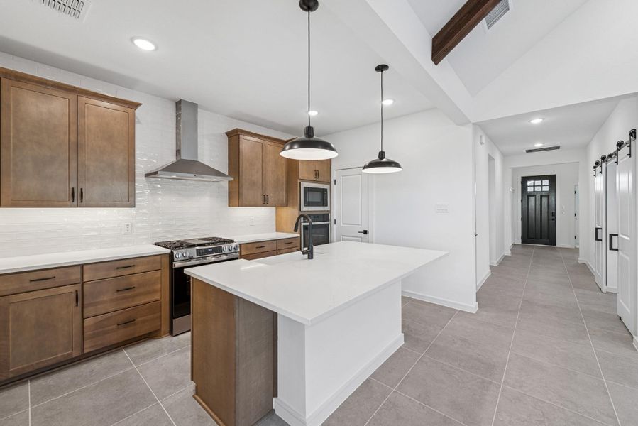 Stylish kitchen with light stain cabinets and quartz counters (*Photo not of actual home and used for illustration purposes only.) Stylish kitchen with light stain cabinets and quartz counters (*Photo not of actual home and used for illustration purposes only.)
