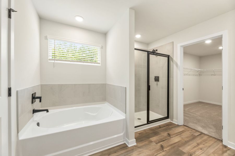 A bathroom with a tub and shower. A bathroom with a tub and shower.