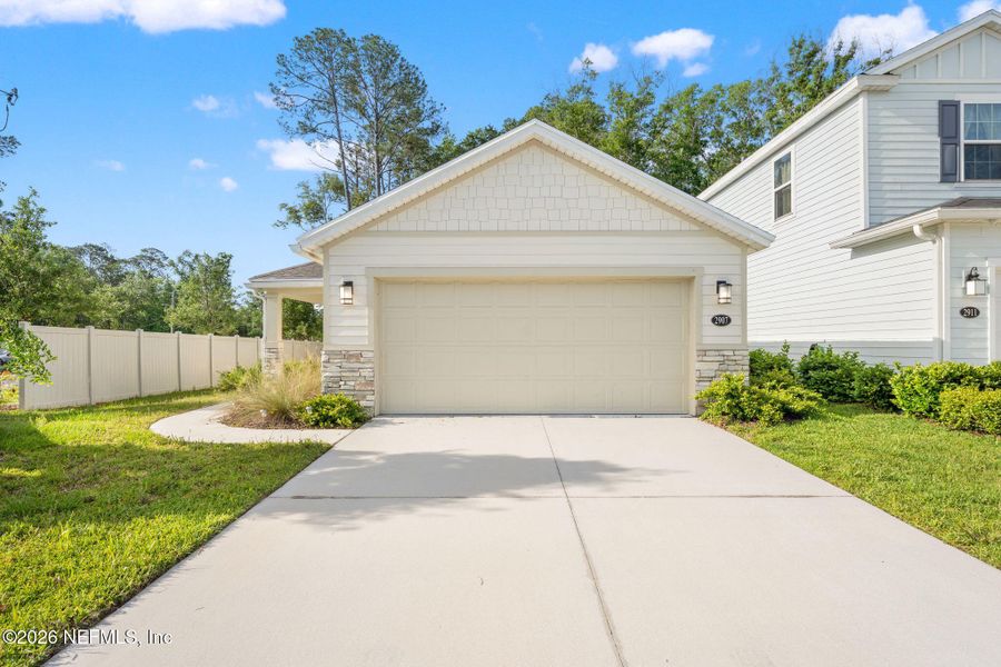 Front exterior of a new home in Pinewood Place, Middleburg, FL, highlighting curb appeal (Image 2). Front exterior of a new home in Pinewood Place, Middleburg, FL, highlighting curb appeal (Image 2).