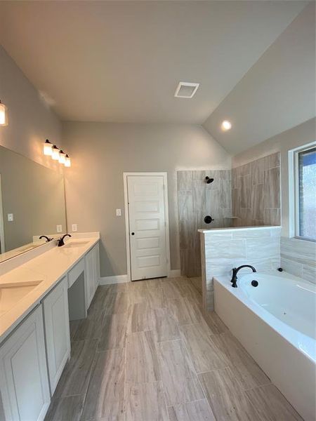 Spa-like master bathroom with 12x24 light grey tile, white cabinets,and Calacatta Lincoln white w/grey veined quartz counters Spa-like master bathroom with 12x24 light grey tile, white cabinets,and Calacatta Lincoln white w/grey veined quartz counters