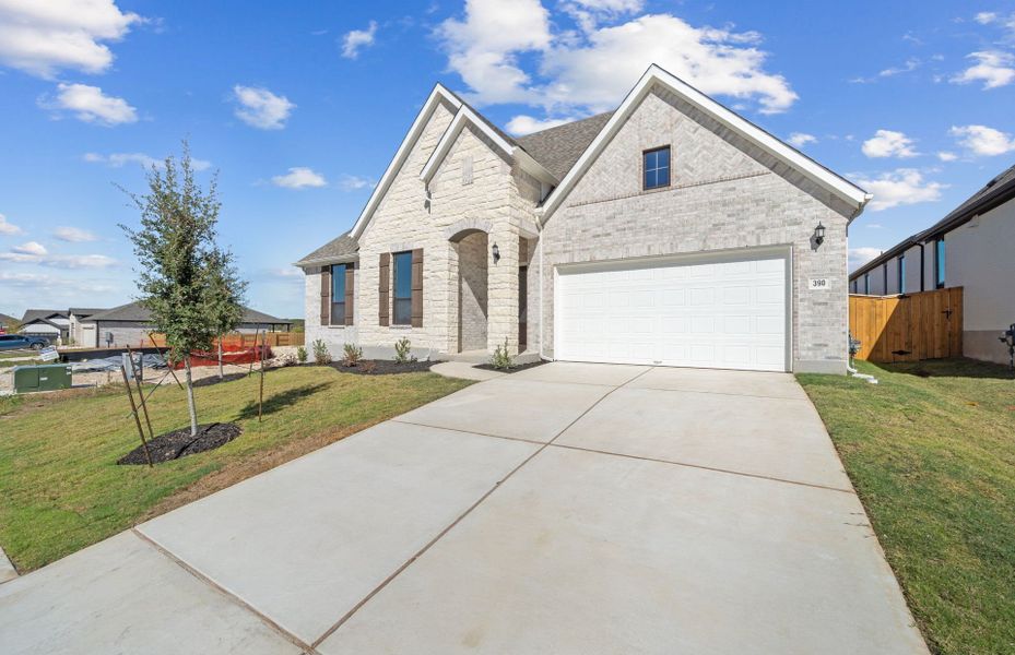 Front exterior of a new home in 6 Creeks, Kyle, TX, highlighting curb appeal (Image 26). Front exterior of a new home in 6 Creeks, Kyle, TX, highlighting curb appeal (Image 26).