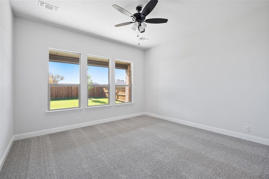 Spare room featuring carpet flooring and ceiling fan
