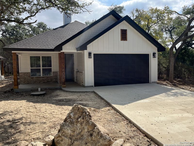 Front exterior of a new home in , Wimberley, TX, highlighting curb appeal (Image 1).