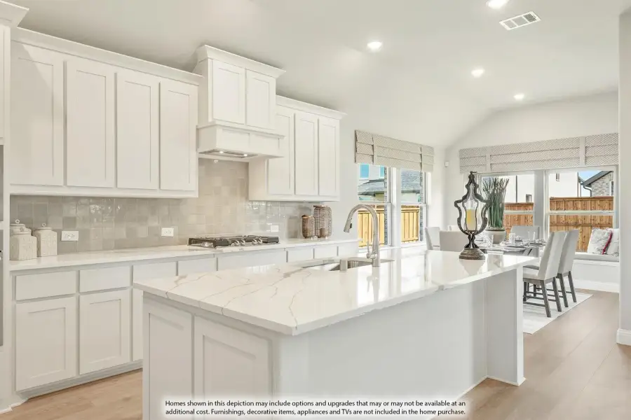 Kitchen with white cabinets, quartz island, tile backsplash, and gas cooktop open to dining area Kitchen with white cabinets, quartz island, tile backsplash, and gas cooktop open to dining area