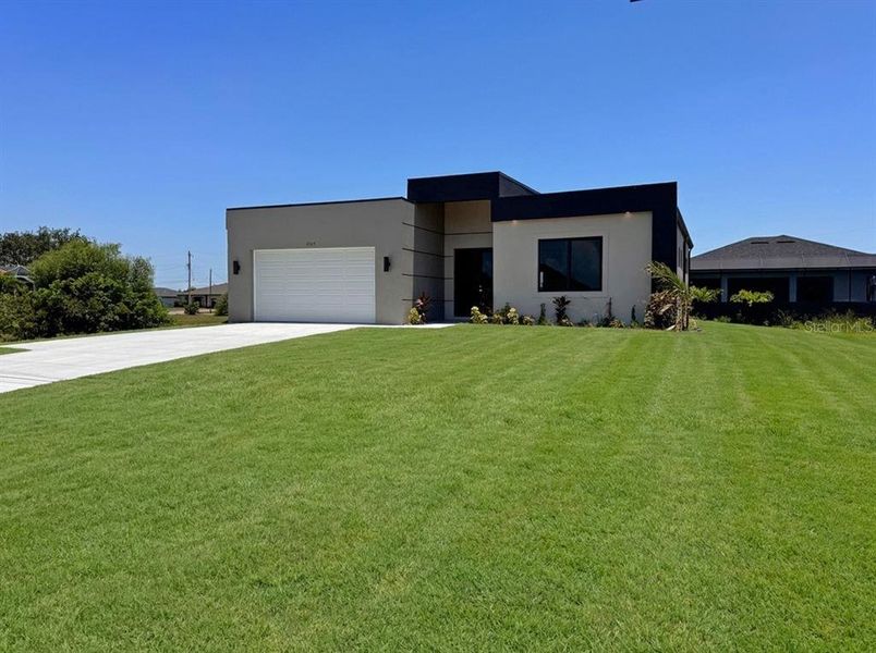 Front exterior of a new home in , Cape Coral, FL, highlighting curb appeal (Image 1). Front exterior of a new home in , Cape Coral, FL, highlighting curb appeal (Image 1).