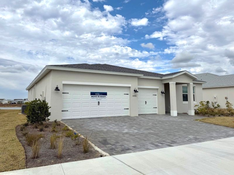 Front exterior of a new home in Crescent Lakes - Signature Series, Punta Gorda, FL, highlighting curb appeal (Image 8).