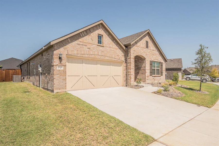 View of front of property featuring brick siding, a front lawn, concrete driveway, and an attached garage View of front of property featuring brick siding, a front lawn, concrete driveway, and an attached garage