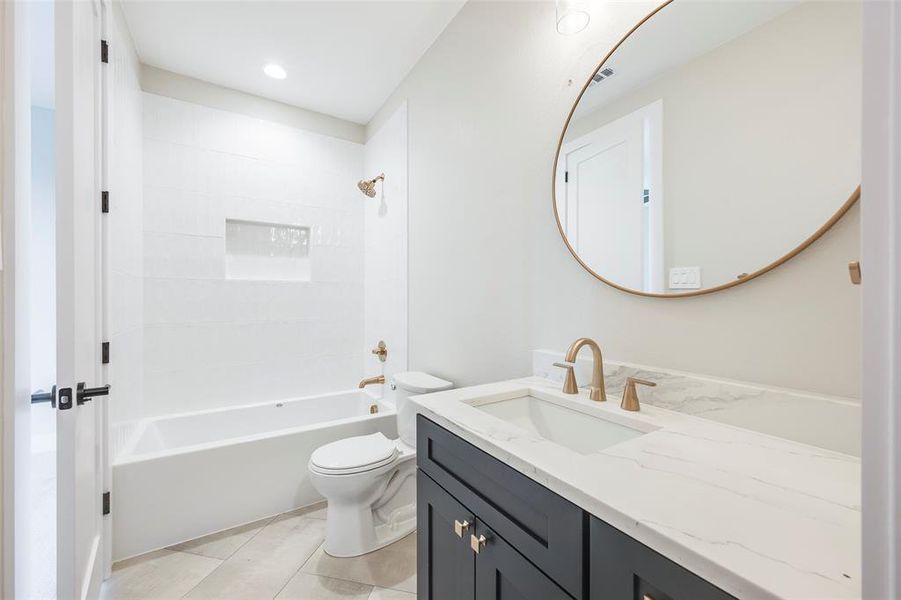Full bath featuring shower / bathtub combination, vanity, light tile patterned flooring, and recessed lighting