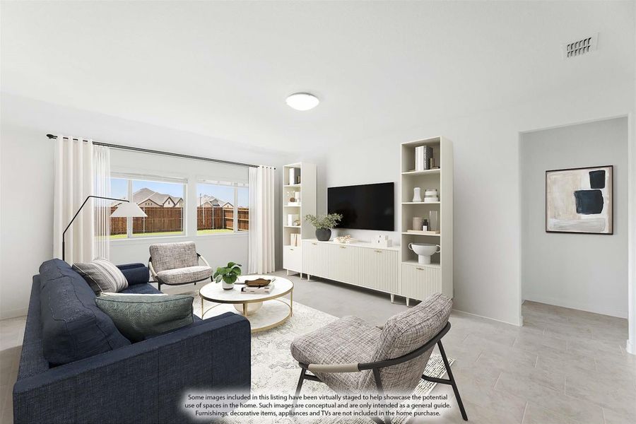 Living room with navy sofa, white built-in shelving, wall-mounted TV, and large windows with neighborhood view