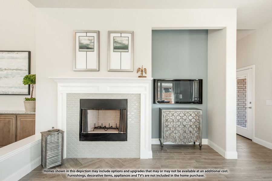 Living room fireplace with white mantel and tile surround, next to a blue accent wall niche with TV and cabinet Living room fireplace with white mantel and tile surround, next to a blue accent wall niche with TV and cabinet