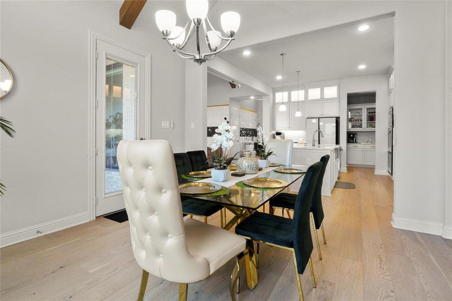 Dining space with light wood finished floors, healthy amount of natural light, a chandelier, and recessed lighting Dining space with light wood finished floors, healthy amount of natural light, a chandelier, and recessed lighting