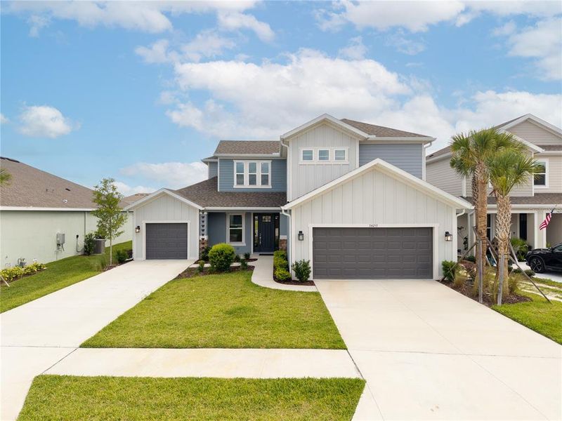 Front exterior of a new home in River Landing, Wesley Chapel, FL, highlighting curb appeal (Image 27). Front exterior of a new home in River Landing, Wesley Chapel, FL, highlighting curb appeal (Image 27).
