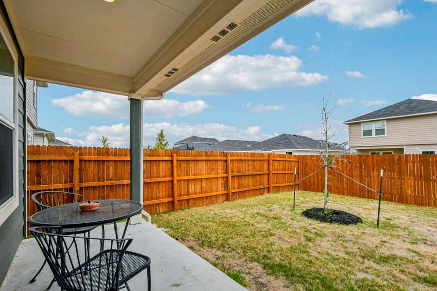 Fenced backyard with a patio