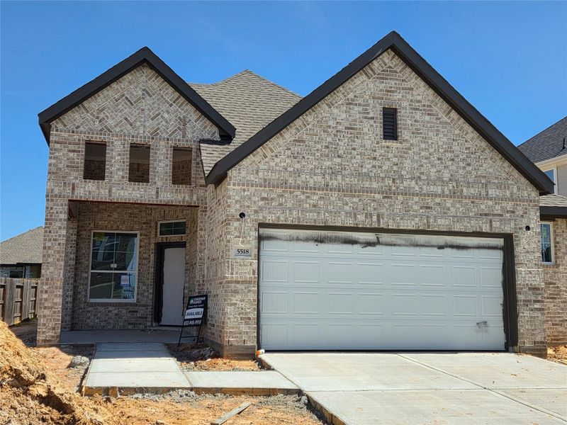 Front exterior of a new home in Sunterra, Katy, TX, highlighting curb appeal (Image 2). Front exterior of a new home in Sunterra, Katy, TX, highlighting curb appeal (Image 2).