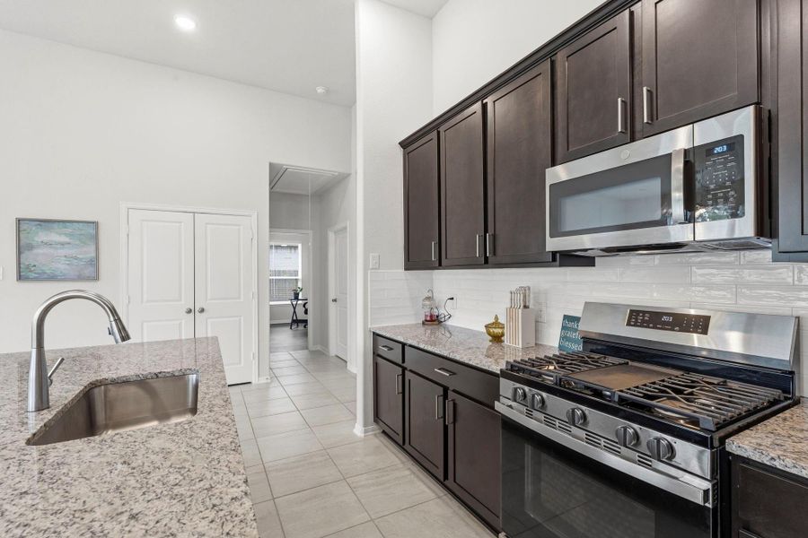 A beautifully designed kitchen with rich cabinetry, granite counters, and abundant prep space for the home chef. A beautifully designed kitchen with rich cabinetry, granite counters, and abundant prep space for the home chef.
