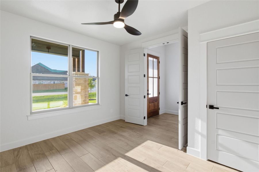 A versatile room with light-toned flooring, a bright window, and a sleek ceiling fan awaits your personal touch. A versatile room with light-toned flooring, a bright window, and a sleek ceiling fan awaits your personal touch.