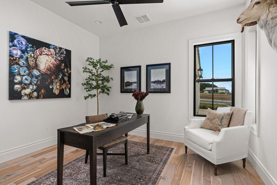 Office space featuring light wood-style flooring and baseboards