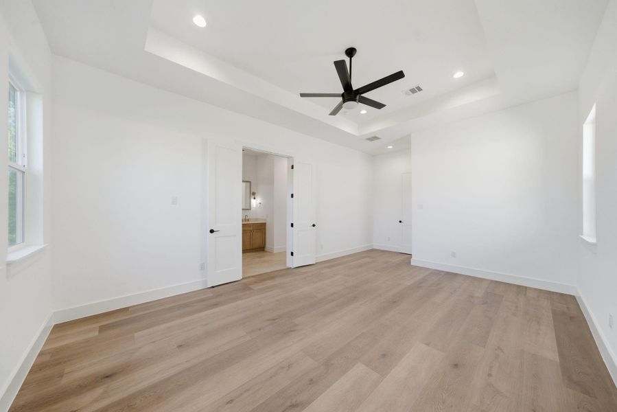 A view of the primary bedroom and en-suite bath. A view of the primary bedroom and en-suite bath.