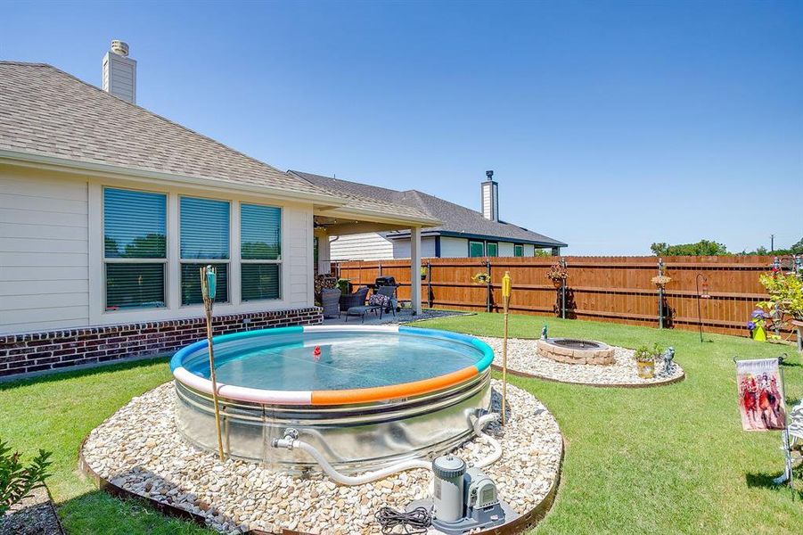 View of swimming pool featuring a patio area and a fire pit View of swimming pool featuring a patio area and a fire pit