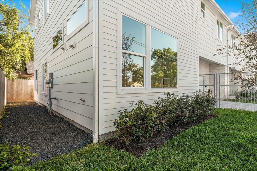 Privately gated front yard with full gutters & French drains, rare features in new construction plus a side yard that leads to the backyard for added convenience. Privately gated front yard with full gutters & French drains, rare features in new construction plus a side yard that leads to the backyard for added convenience.