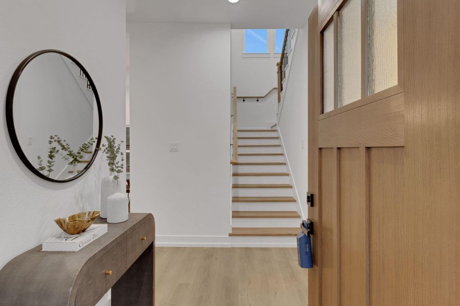 Welcoming foyer with natural wood accents and open staircase leading to the second level. Welcoming foyer with natural wood accents and open staircase leading to the second level.