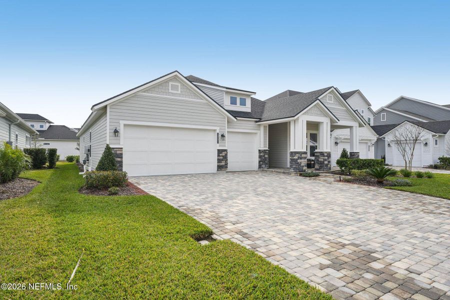 Front exterior of a new home in Middlebourne, St. Johns, FL, highlighting curb appeal (Image 27).