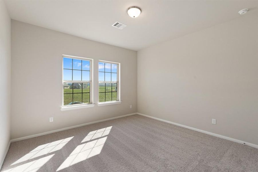 Your secondary bedroom features plush carpet, fresh paint, closet, and a large window that lets in plenty of natural lighting.