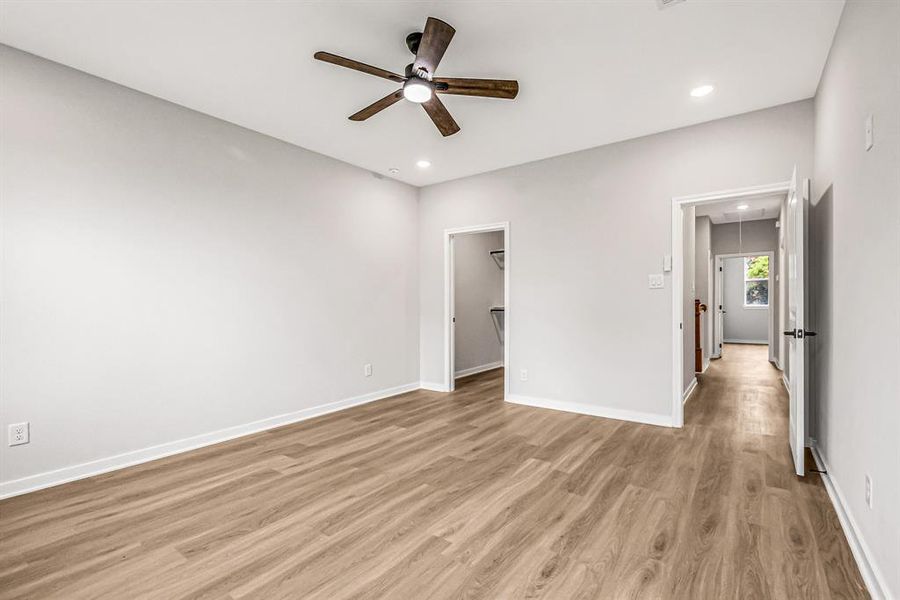 A view of the closet and hallway from the primary bedroom.