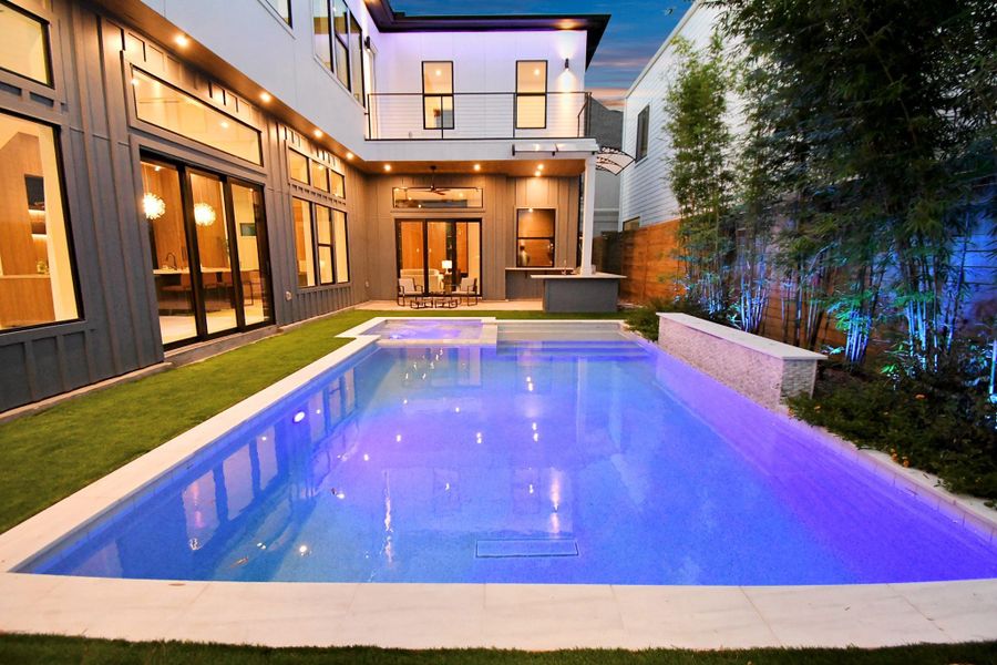 Exterior home has lighting throughout featuring LED lighting, soffit canned lights, and pool lighting.