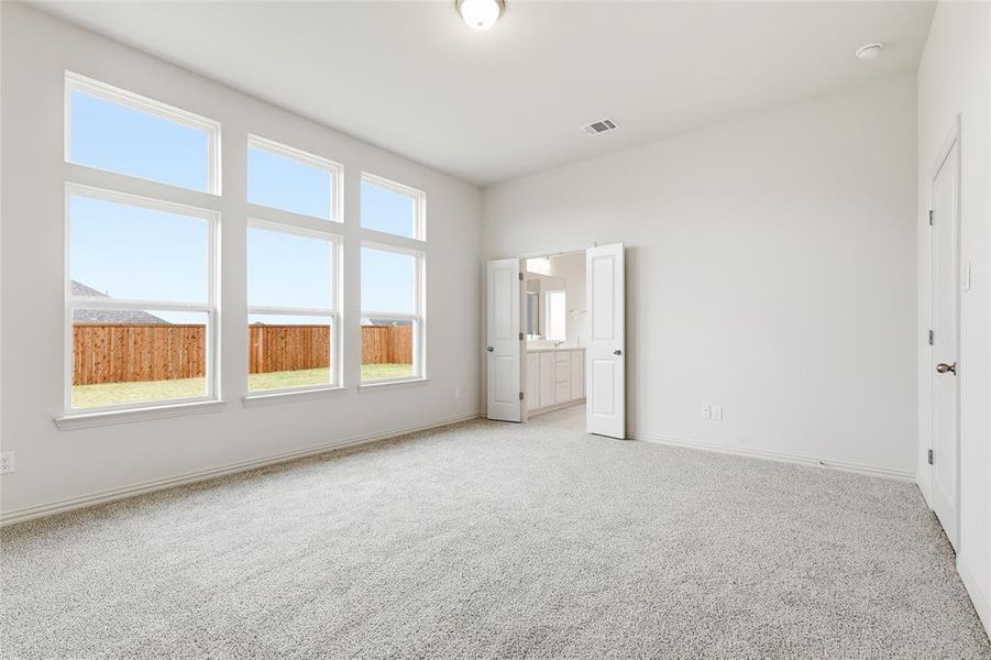 Unfurnished bedroom with carpet and baseboards Unfurnished bedroom with carpet and baseboards