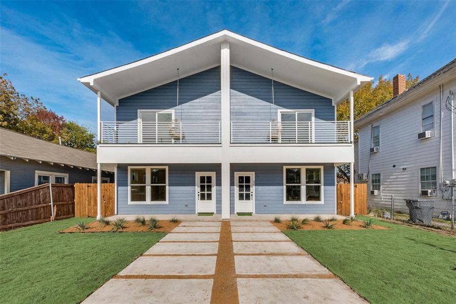 Contemporary home featuring a front lawn, cooling unit, and a balcony