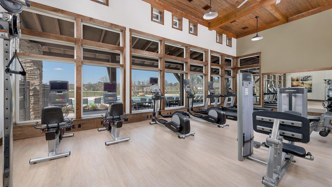 Photo of gym with windows overlooking the pool.