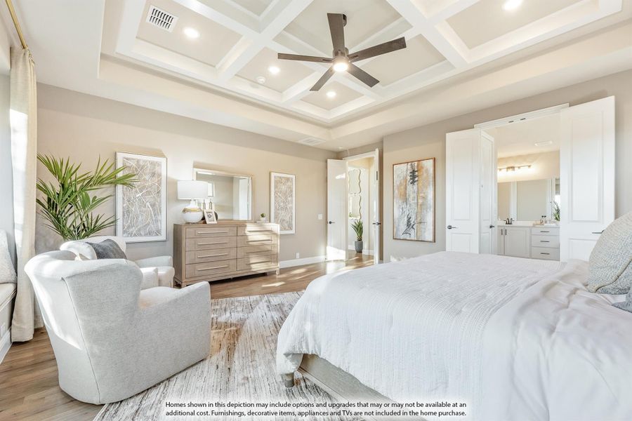 Master bedroom with coffered ceiling, ceiling fan, hardwood floors, and open ensuite bathroom doorway Master bedroom with coffered ceiling, ceiling fan, hardwood floors, and open ensuite bathroom doorway