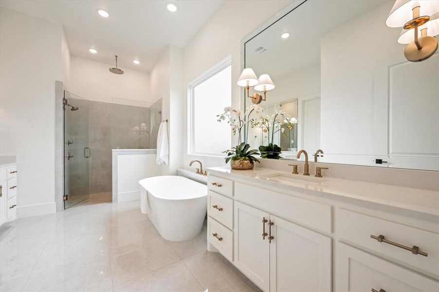 Bathroom with tile patterned flooring, shower with separate bathtub, and vanity