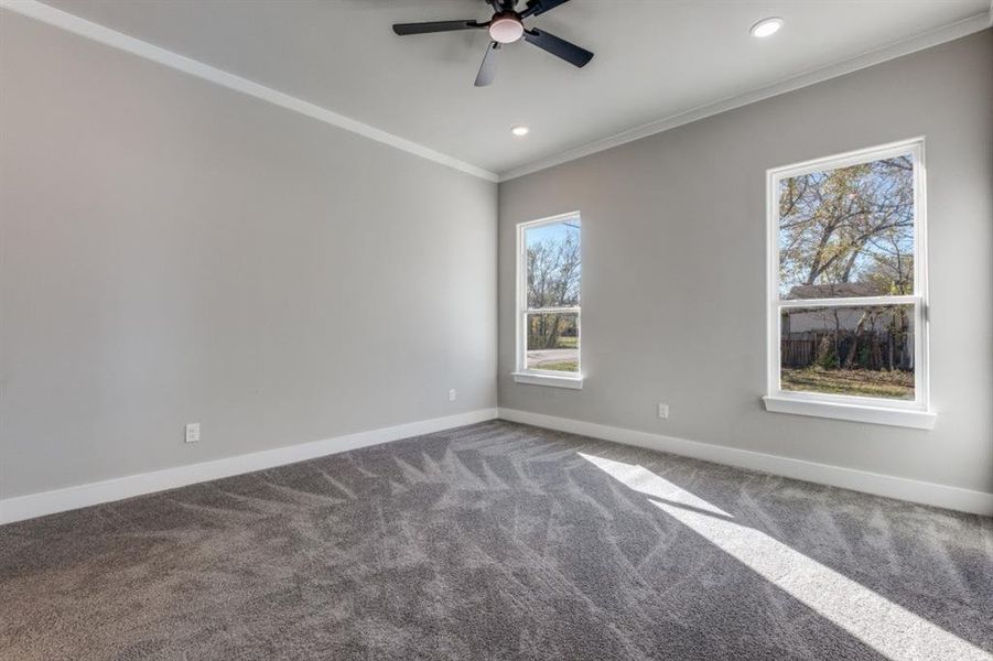 Spare room featuring ornamental molding, carpet flooring, a ceiling fan, and recessed lighting