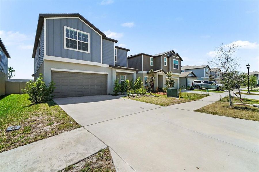 Front exterior of a new home in Two Rivers, Zephyrhills, FL, highlighting curb appeal (Image 22).
